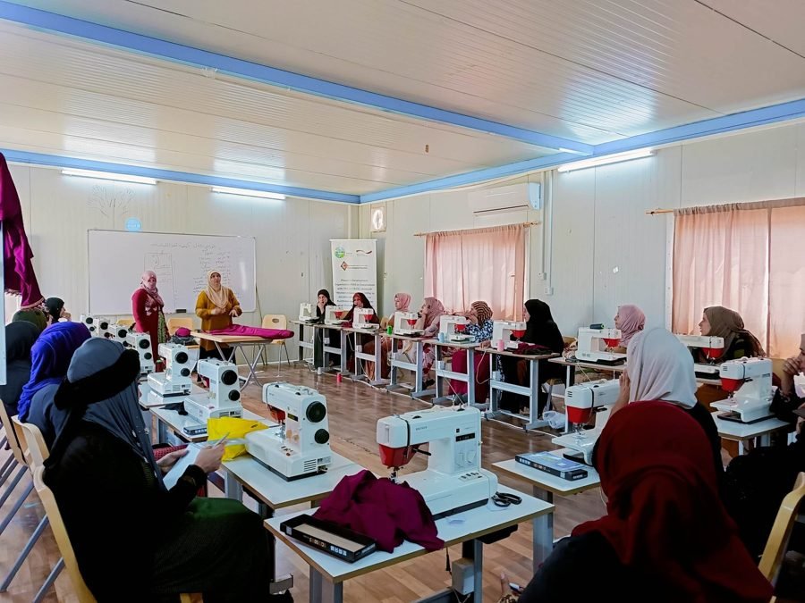Tailoring training: each participant had her own machine and workspace inside a camp classroom.