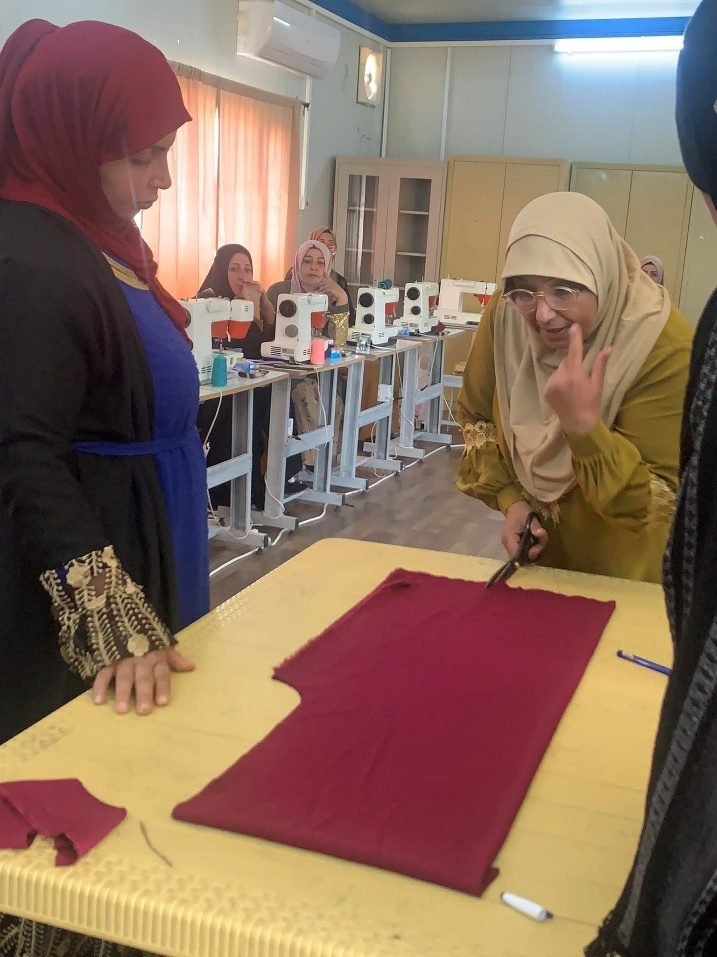 A fabric-cutting demonstration during the sewing course.