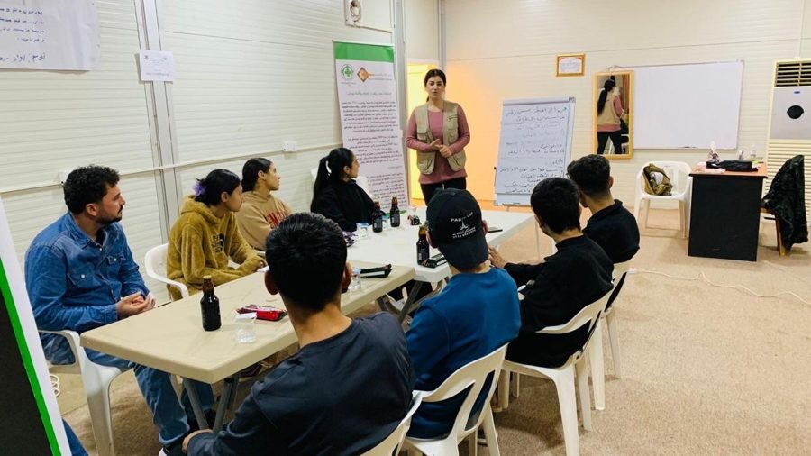 Young people take part in a group discussion at a project centre.